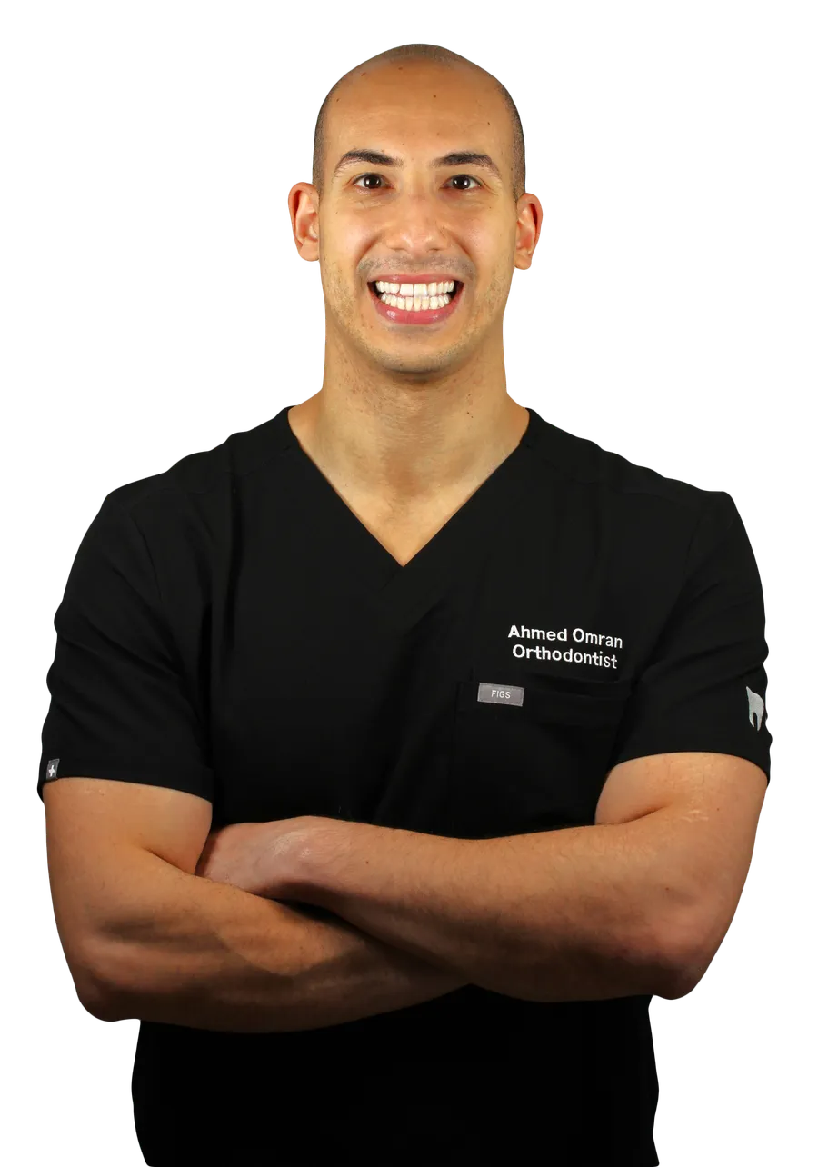Dr Ahmed Omran, specialist orthodontist, in clinic scrubs